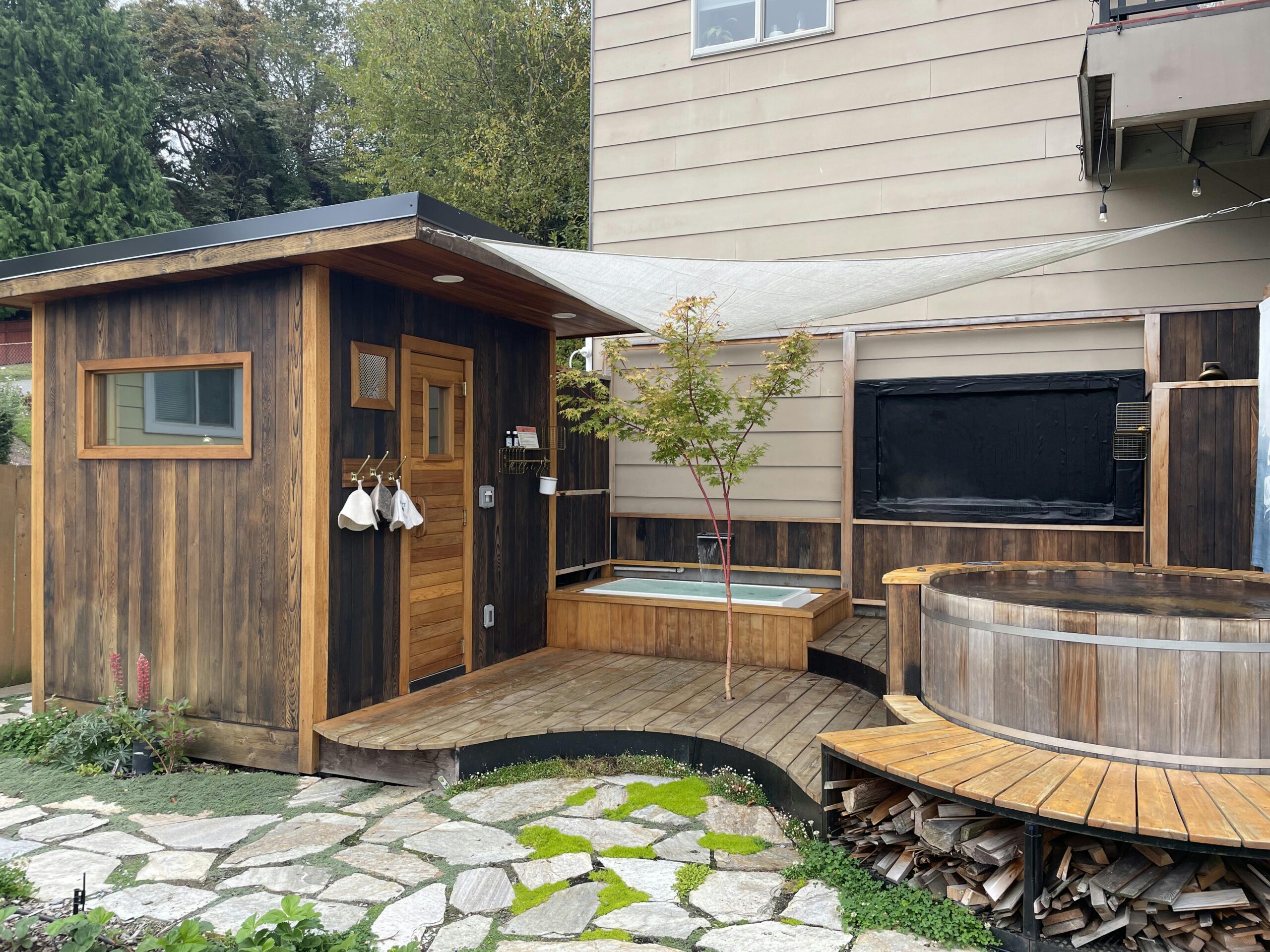 Modern wooden outdoor sauna and cold plunge