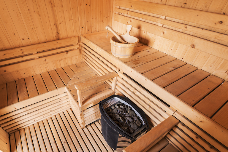 Wooden sauna interior with accessories