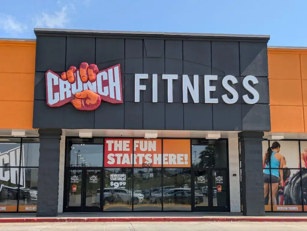 Vibrant Crunch Fitness gym exterior with bold signage, promoting fitness and health, perfect for fitness enthusiasts and promoting active lifestyles.